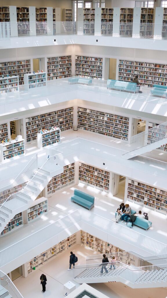 Modern university library interior with students studying across multiple levels